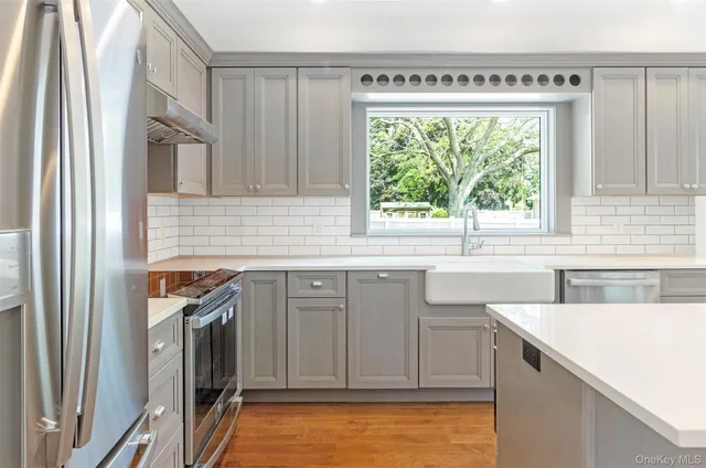 a kitchen with a sink a stove and cabinets