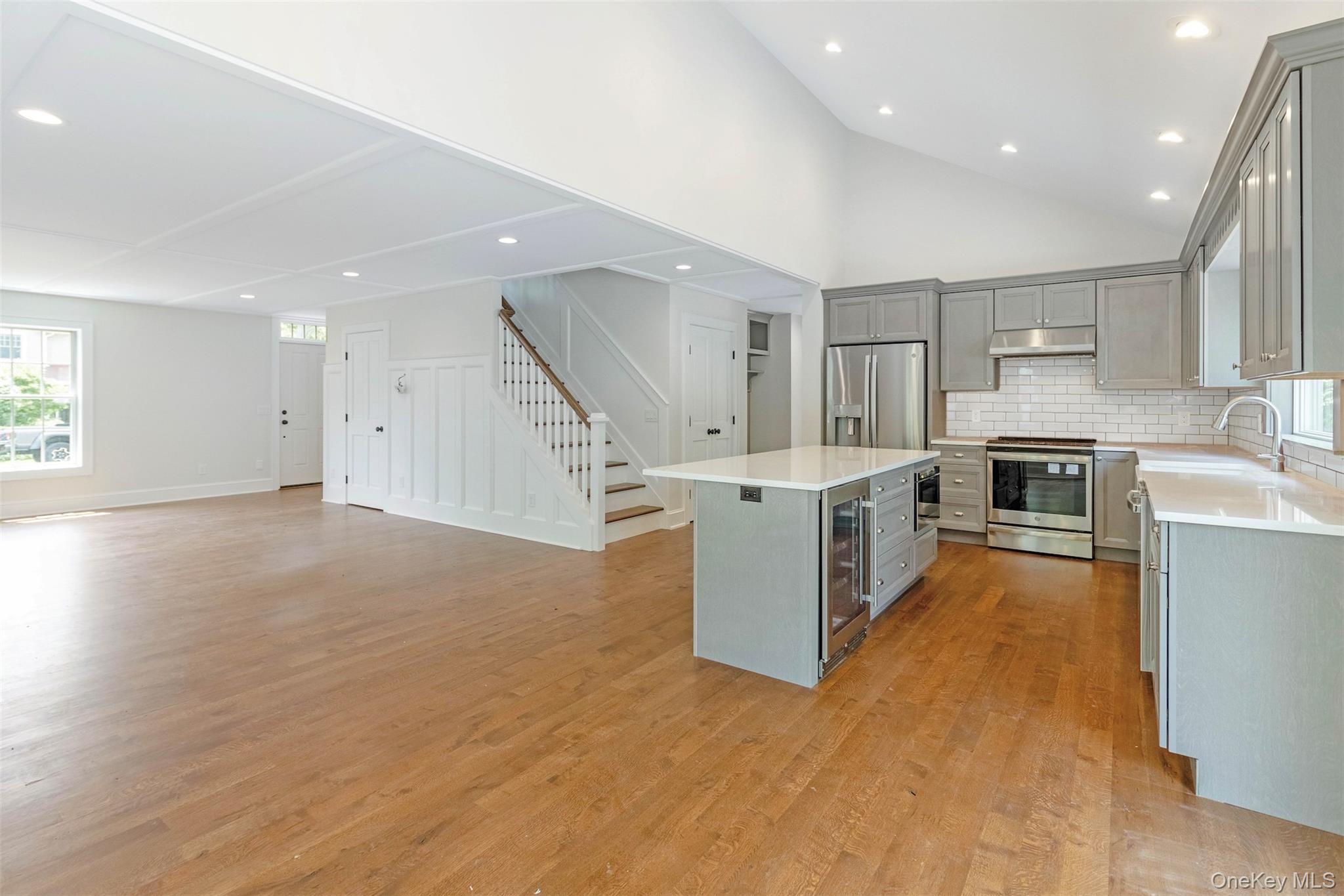 130 Sunset Lane Greenport, NY 11944 - Photo 34 of 34 Kitchen with gray cabinetry, recessed lighting, open floor plan, appliances with stainless steel finishes, and light wood-style flooring