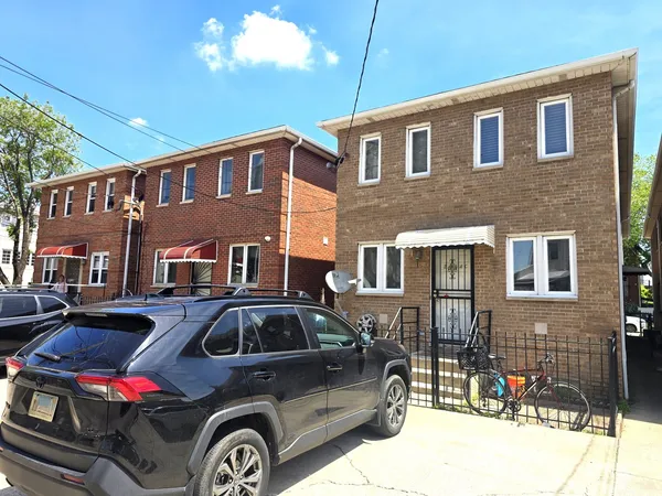 a front view of a house with parking space