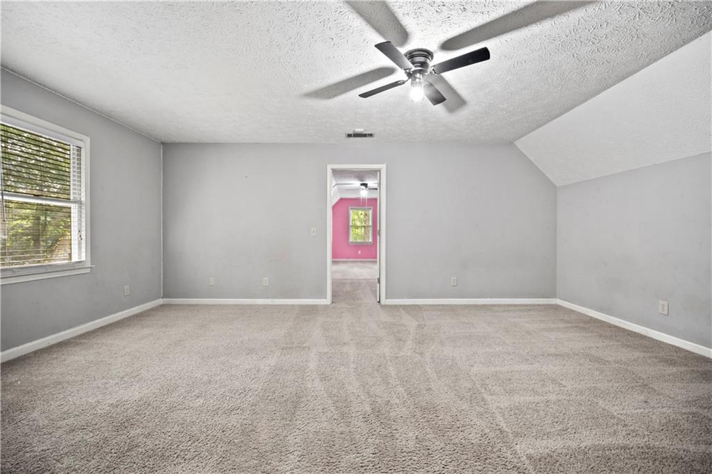 2009 Ben Higgins Road Dahlonega, GA 30533 - Photo 17 of 25 an empty room with windows and fan
