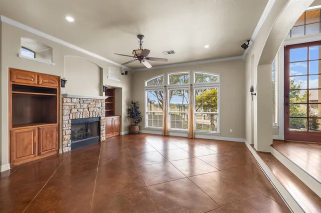 a view of livingroom with furniture wooden floor flat screen tv and windows