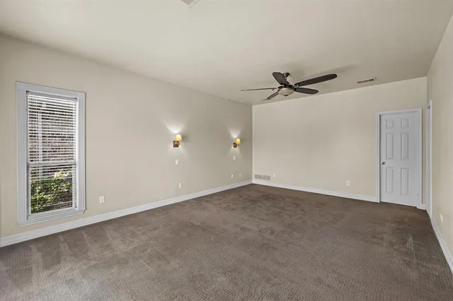 a view of a livingroom with a ceiling fan and window