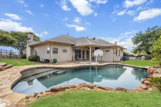 a view of a house with swimming pool and a yard