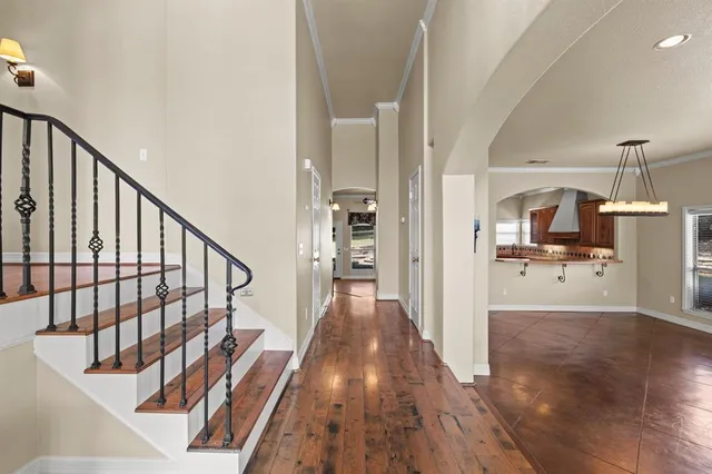 a view of a hallway view with wooden floor and staircase