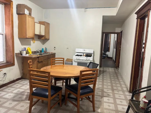 a dining room with furniture and window