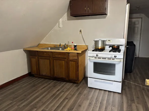 a view of a kitchen with stove and cabinets