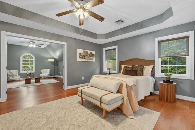 a bedroom with a large bed and a chandelier