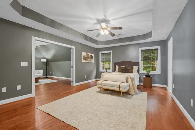 a bedroom with a large bed and a chandelier