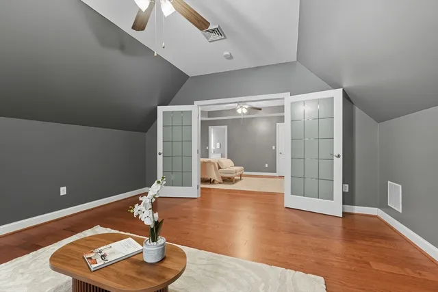 a living room with furniture and a glass door