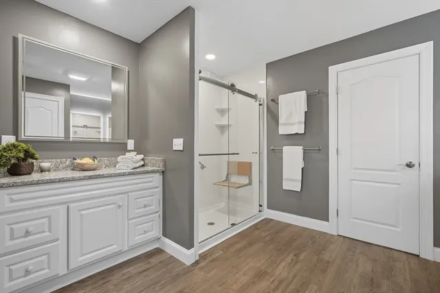 a bathroom with a shower sink and mirror