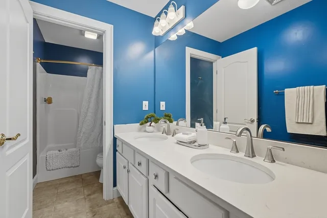 a bathroom with a double vanity sink and a mirror