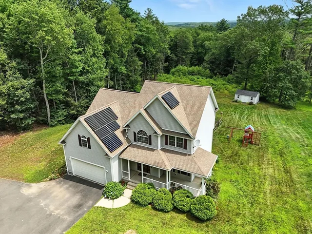 an aerial view of a house with a yard
