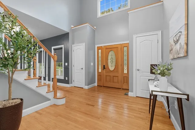 a view of a hallway with furniture and front door