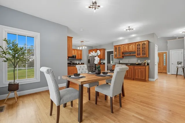 a view of a dining room with furniture window and wooden floor