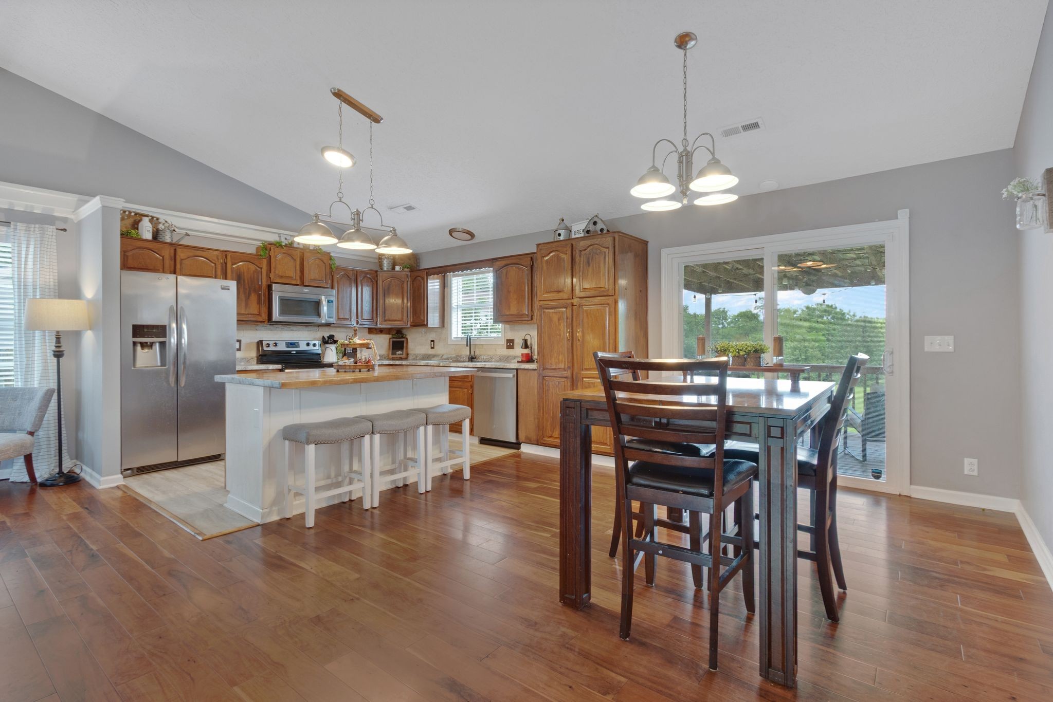 2137 Lee Road Spring Hill, TN 37174 - Photo 12 of 49 a view of a dining room and livingroom with furniture wooden floor a chandelier