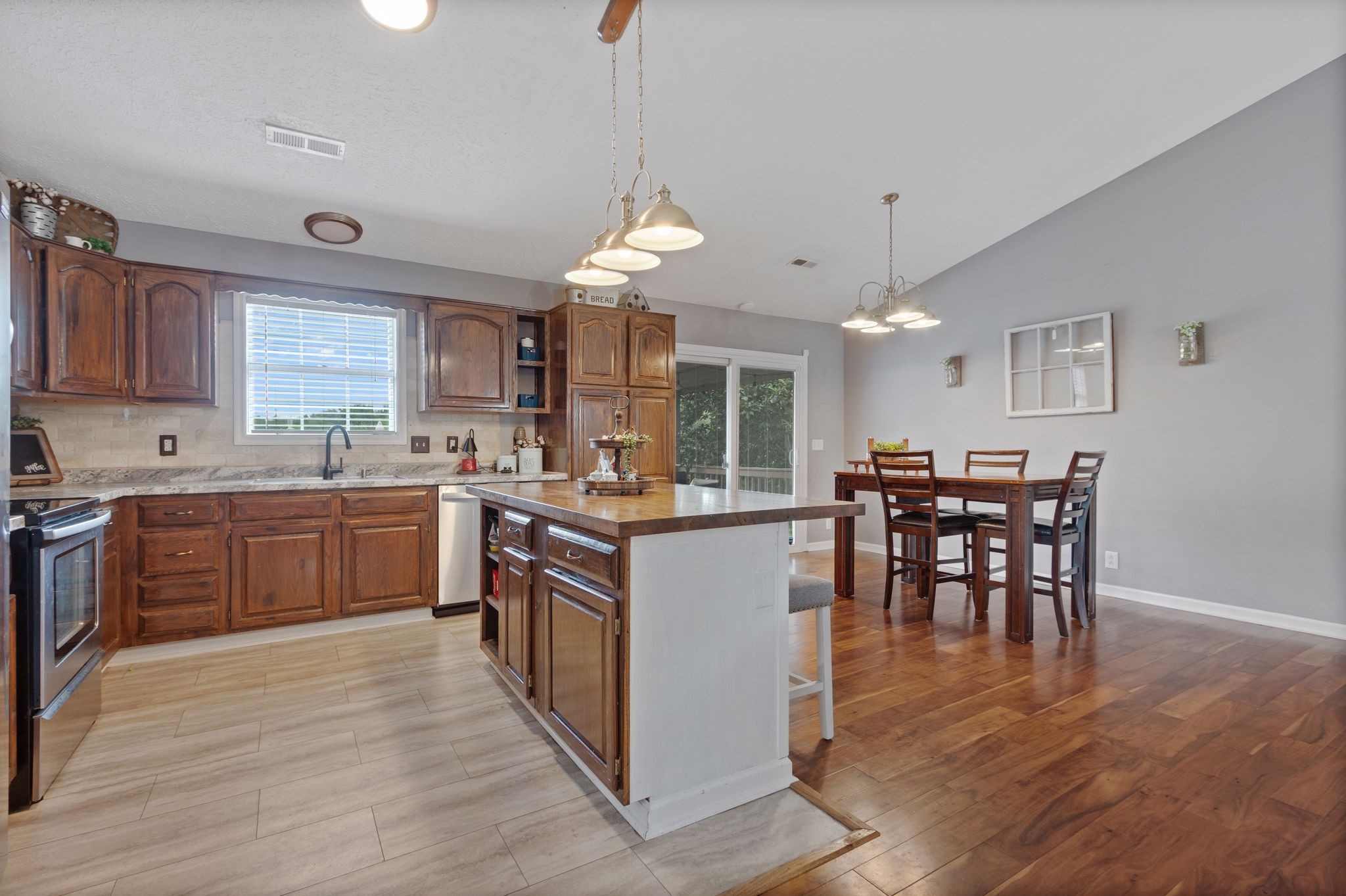 2137 Lee Road Spring Hill, TN 37174 - Photo 16 of 49 a kitchen with stainless steel appliances granite countertop wooden floors and white cabinets