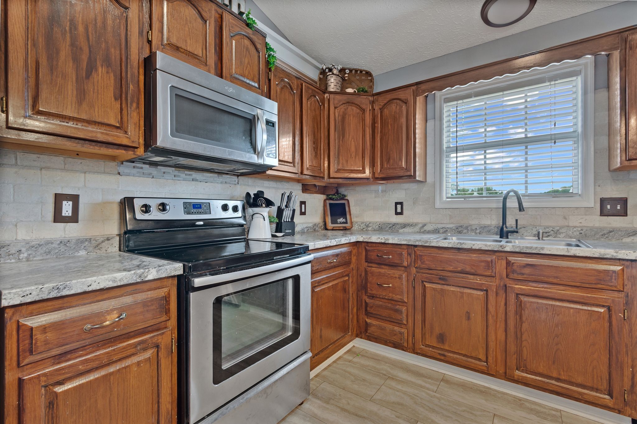 2137 Lee Road Spring Hill, TN 37174 - Photo 17 of 49 a kitchen with stainless steel appliances granite countertop a sink a stove and cabinets