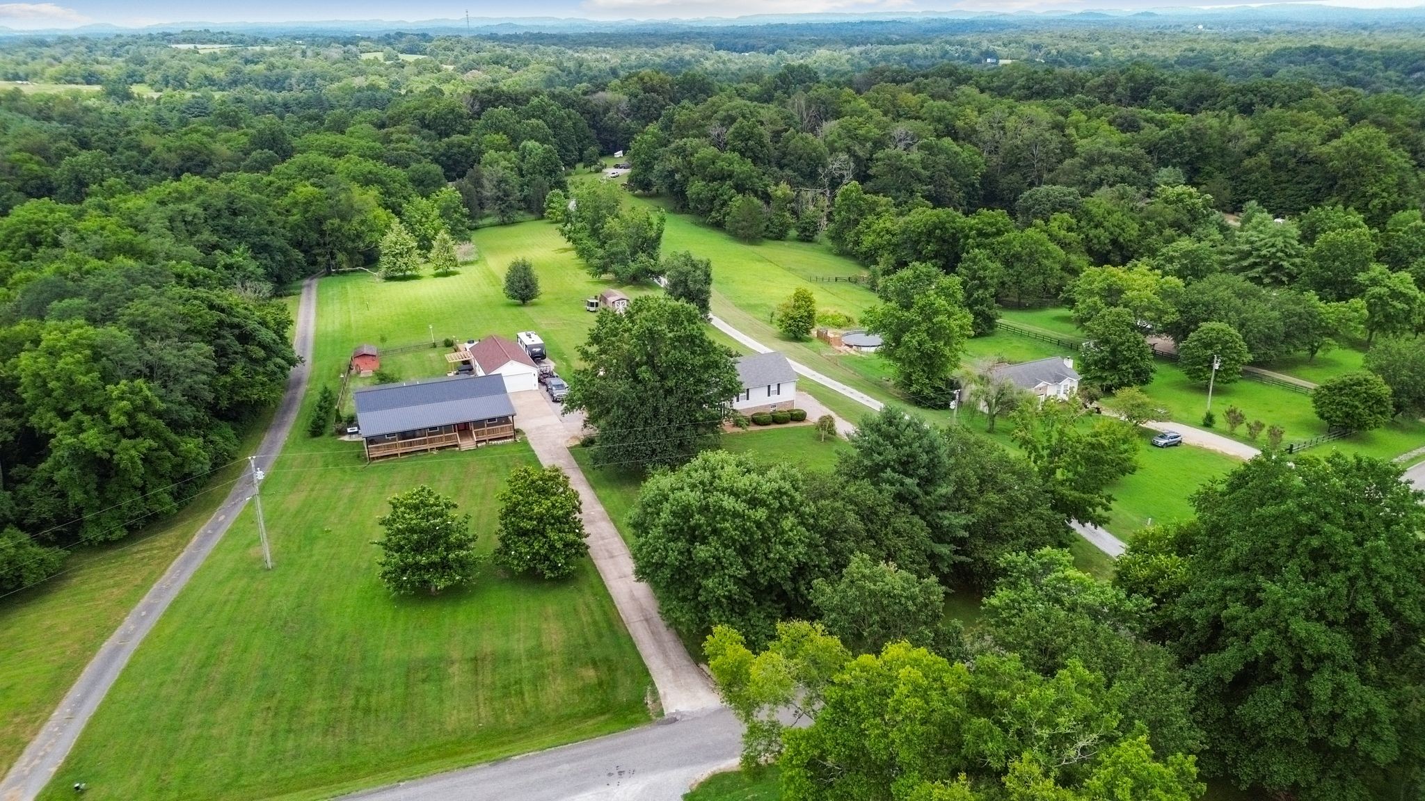 2137 Lee Road Spring Hill, TN 37174 - Photo 4 of 49 an aerial view of green landscape with trees houses and mountain view