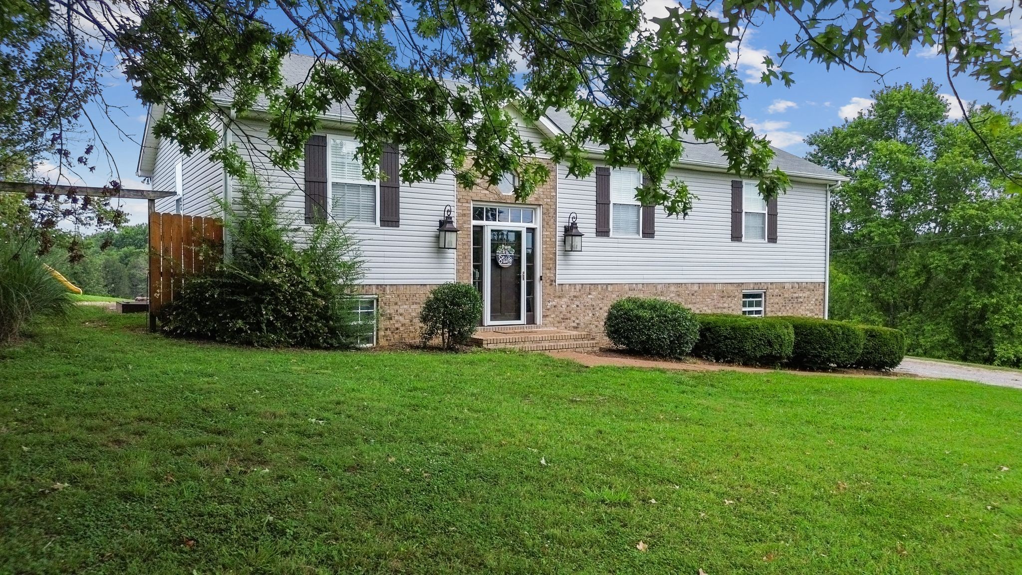 2137 Lee Road Spring Hill, TN 37174 - Photo 5 of 49 a view of a house with backyard and a tree