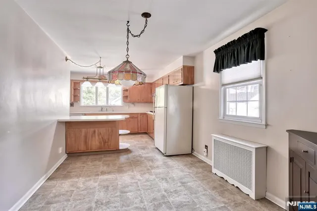 a kitchen with refrigerator and window