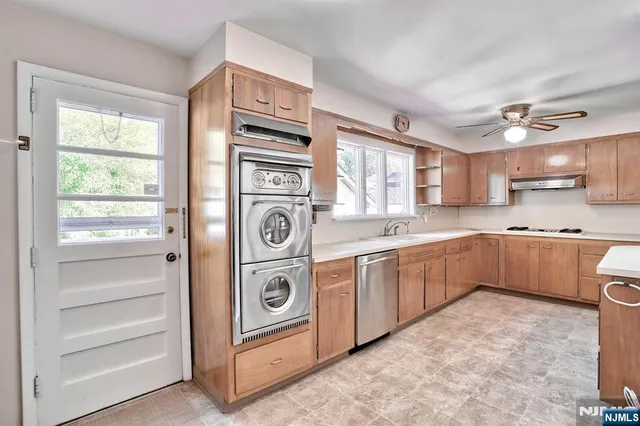 a kitchen with a stove top oven sink and cabinets