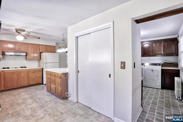 a kitchen with stainless steel appliances a refrigerator and a stove top oven