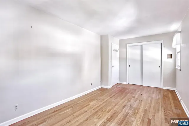 a view of a room with wooden floor