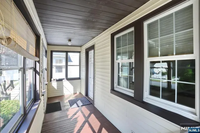 a view of a large room with wooden floor and windows