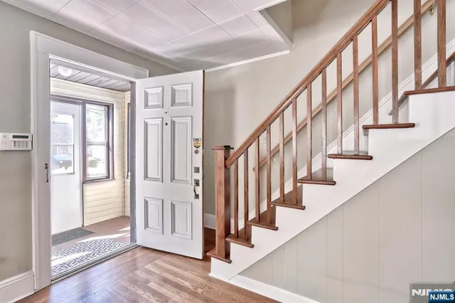 a view of entryway with wooden floor and stairs