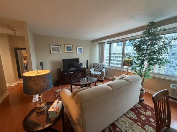 a living room with furniture and a floor to ceiling window