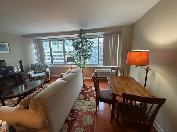 a living room with furniture a large window and a flat screen tv