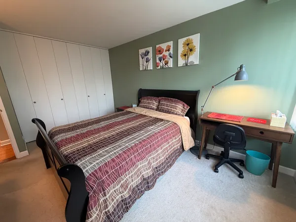 a bedroom with a bed and a chair