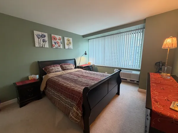 a bed room with a bed and a lamp