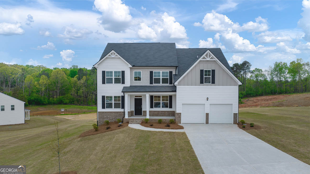 704 Ralph Still Road, Unit 43 Dacula, GA 30019 - Photo 1 of 1 a front view of a house with garden