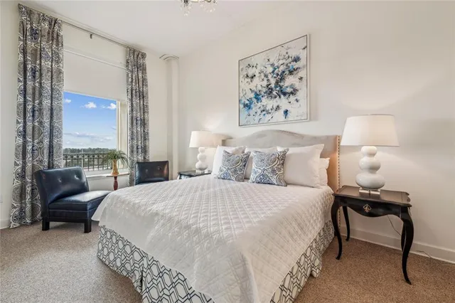 a bedroom with a bed and a large window