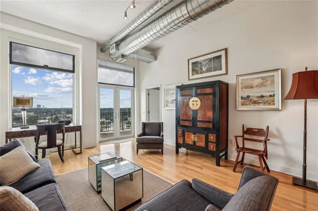 a living room with furniture and large windows