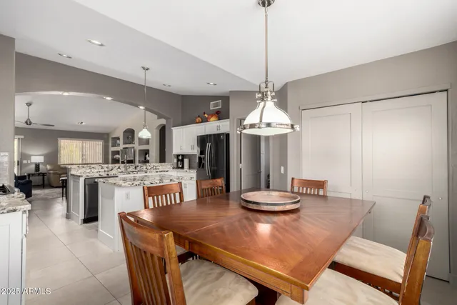 a view of a dining room with furniture large windows and wooden floor