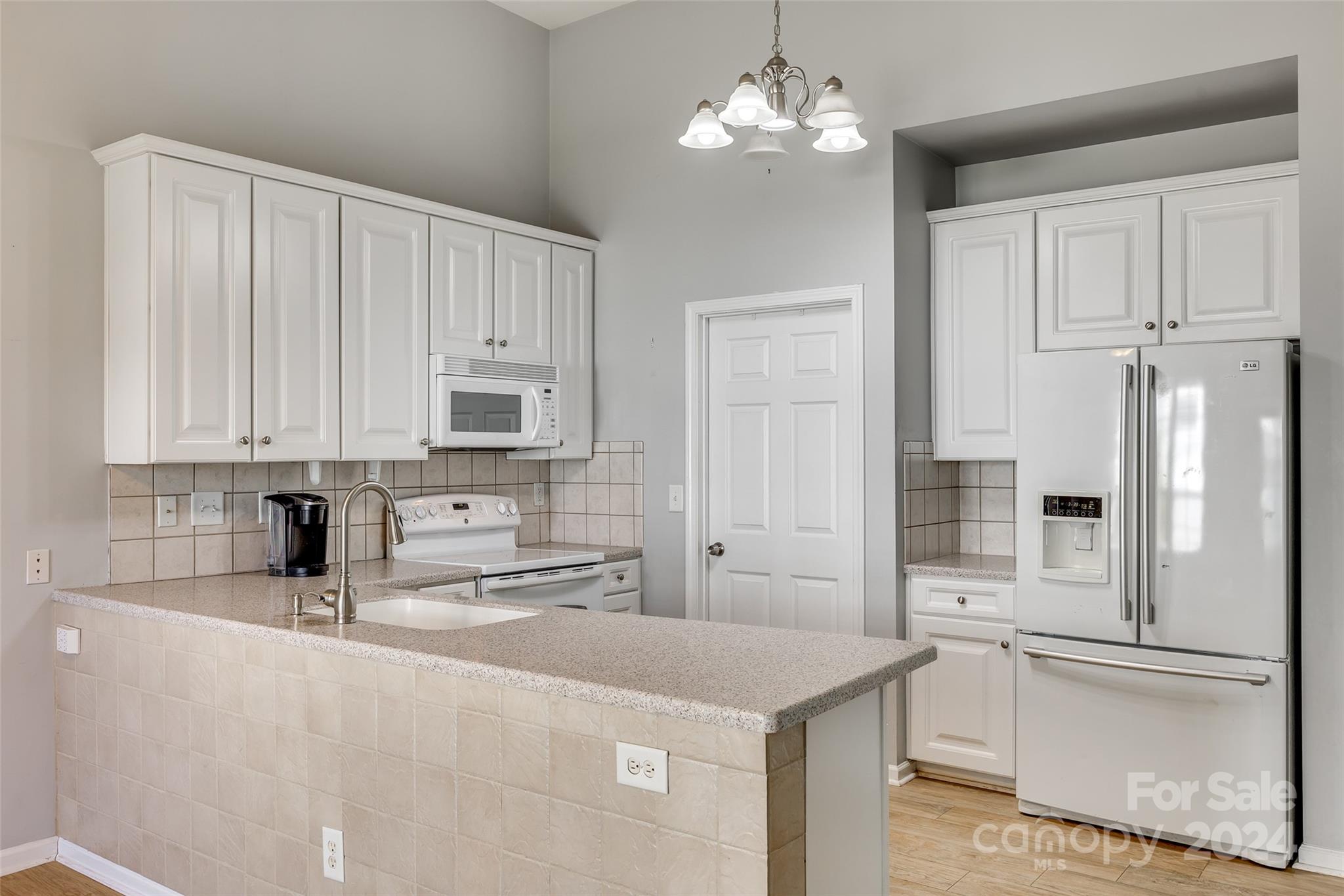 5514 Alexandrite Way Fort Mill, SC 29708 - Photo 15 of 42 a kitchen with stainless steel appliances a sink a refrigerator a stove a microwave and cabinets