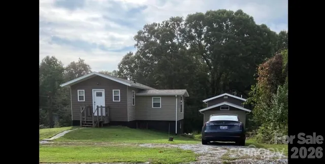 a front view of a house with a garden and yard
