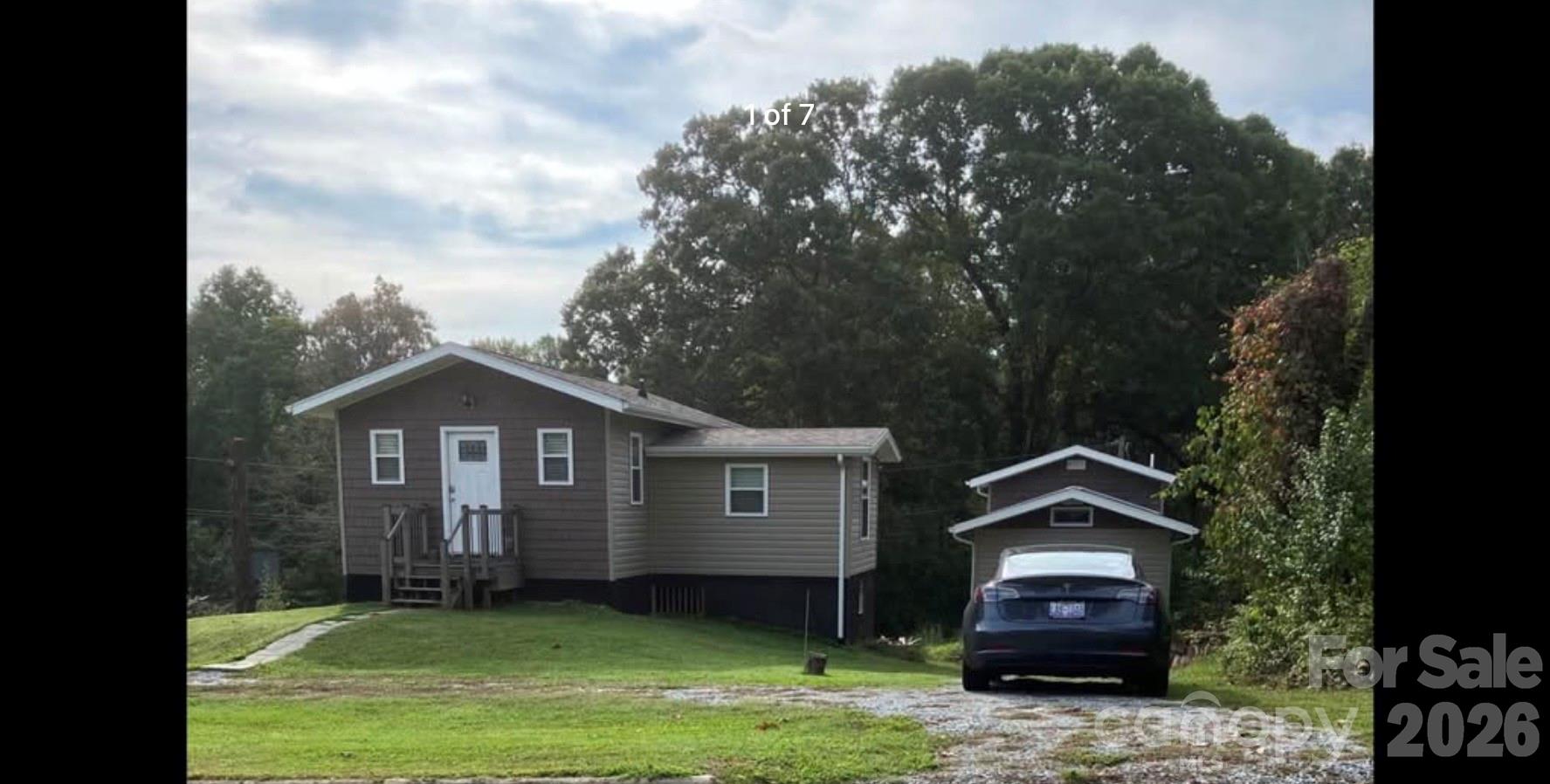 a front view of a house with a garden and yard