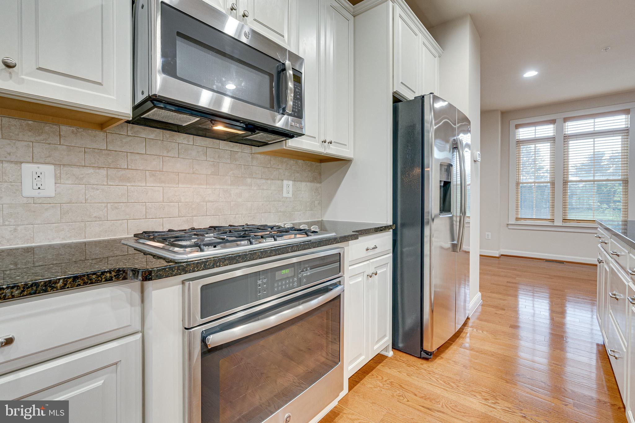 11357 Ridgeline Road Fairfax, VA 22030 - Photo 14 of 57 a kitchen with stainless steel appliances granite countertop a stove and a microwave