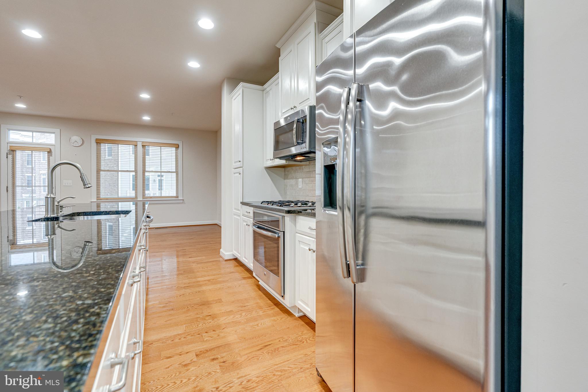 11357 Ridgeline Road Fairfax, VA 22030 - Photo 15 of 57 a kitchen with granite countertop a refrigerator and a sink