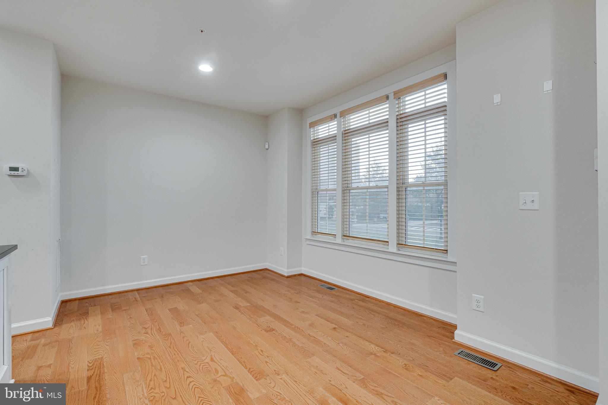 11357 Ridgeline Road Fairfax, VA 22030 - Photo 16 of 57 an empty room with wooden floor and windows