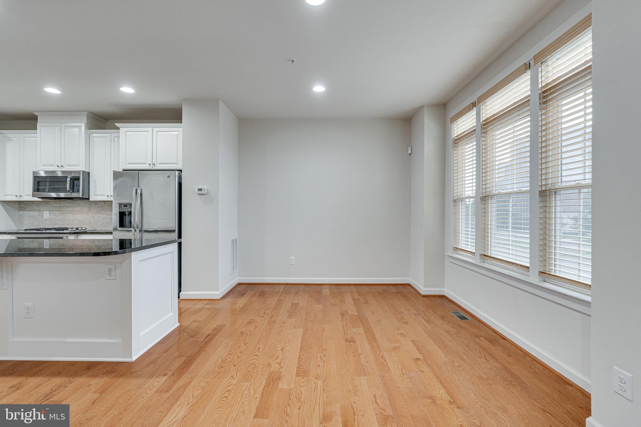 11357 Ridgeline Road Fairfax, VA 22030 - Photo 17 of 57 a kitchen with granite countertop a stove a sink and a refrigerator