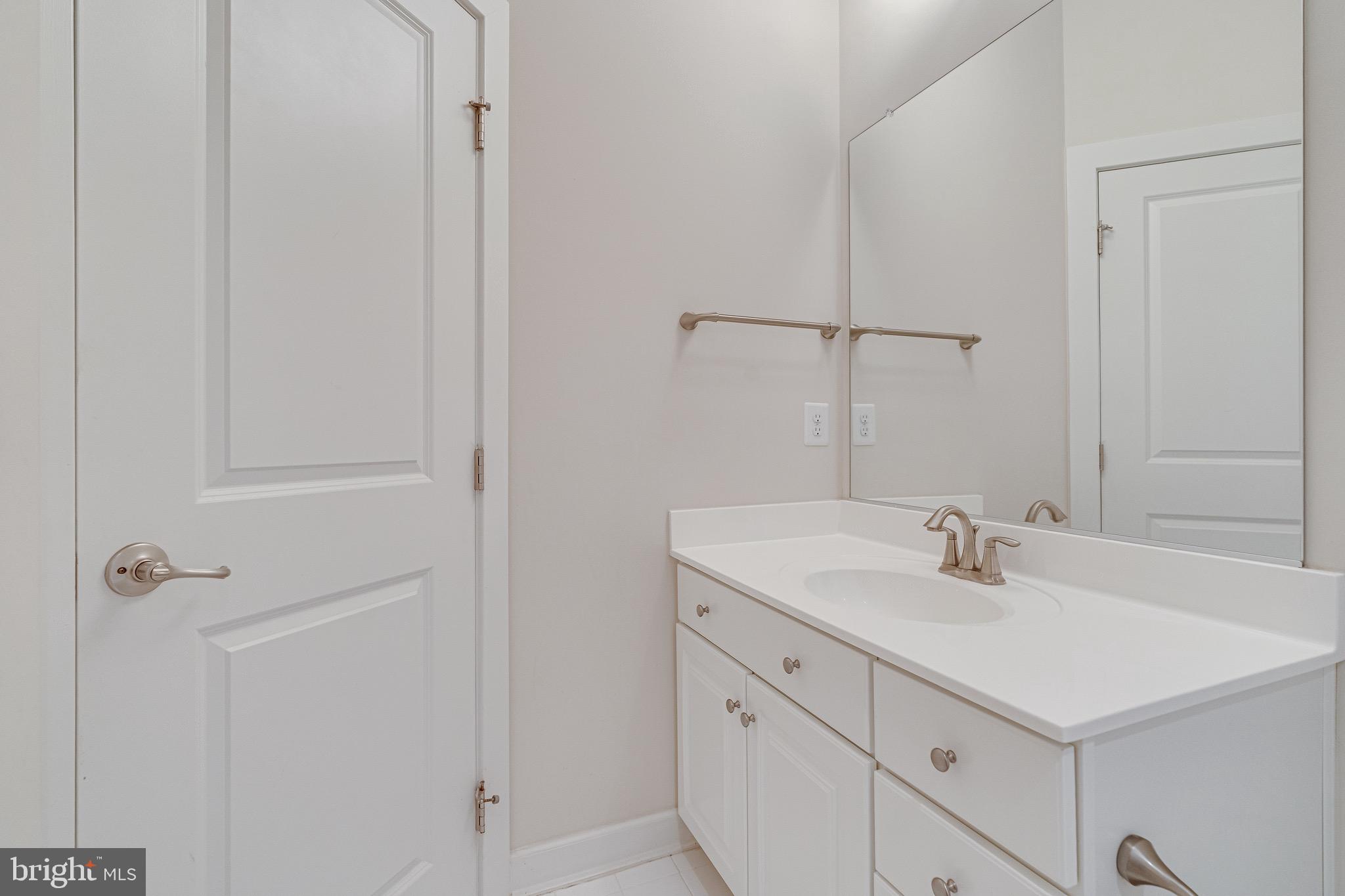 11357 Ridgeline Road Fairfax, VA 22030 - Photo 32 of 57 a bathroom with a sink and a mirror