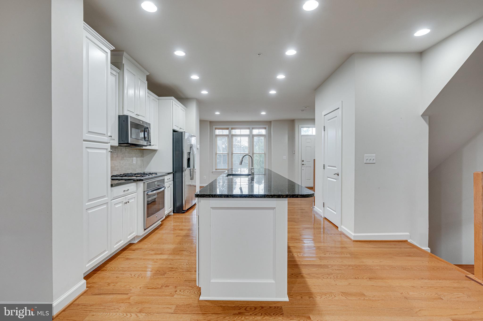 11357 Ridgeline Road Fairfax, VA 22030 - Photo 9 of 57 a large kitchen with stainless steel appliances granite countertop a large counter top and a stove top oven