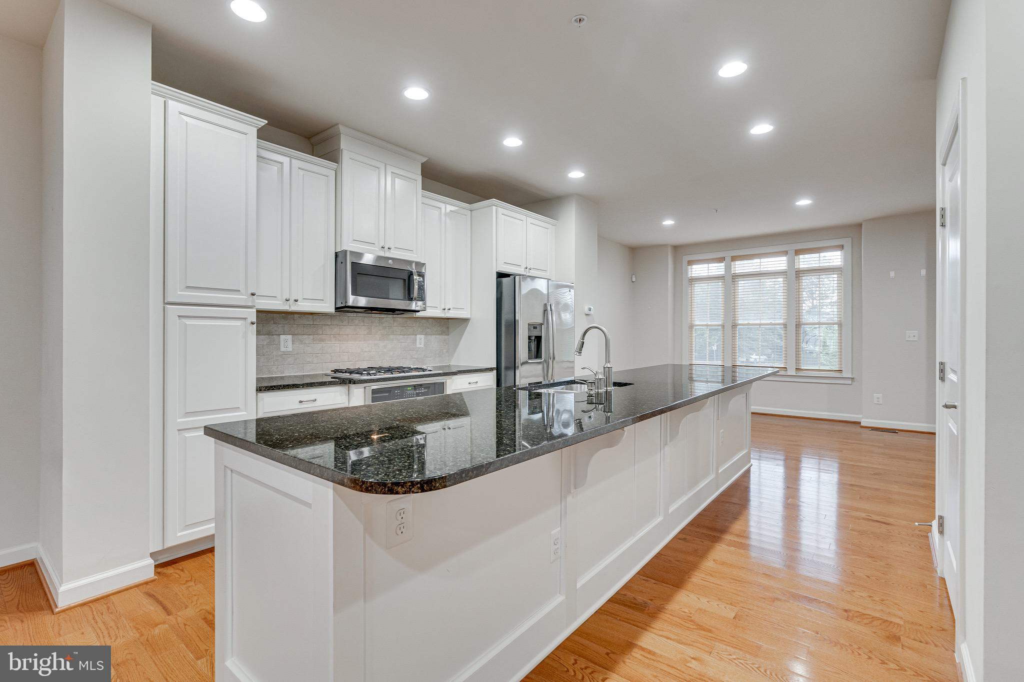 11357 Ridgeline Road Fairfax, VA 22030 - Photo 10 of 57 a kitchen with stainless steel appliances granite countertop a sink a stove and a refrigerator