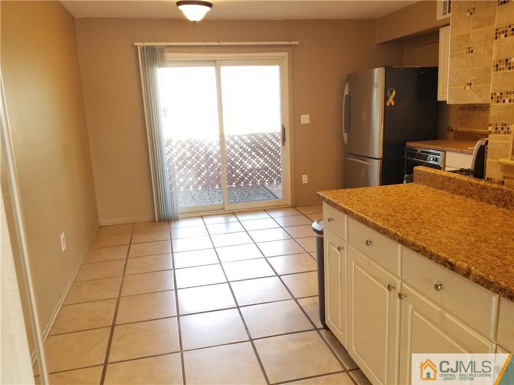 197 Evergreen Road, Unit 3B Edison, NJ 08837 - Photo 12 of 20 a kitchen with a sink a refrigerator and a stove top oven