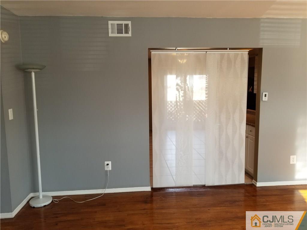 197 Evergreen Road, Unit 3B Edison, NJ 08837 - Photo 13 of 20 a view of room with window and wooden floor