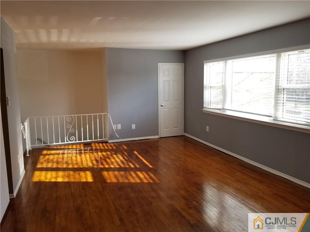 197 Evergreen Road, Unit 3B Edison, NJ 08837 - Photo 15 of 20 an empty room with wooden floor